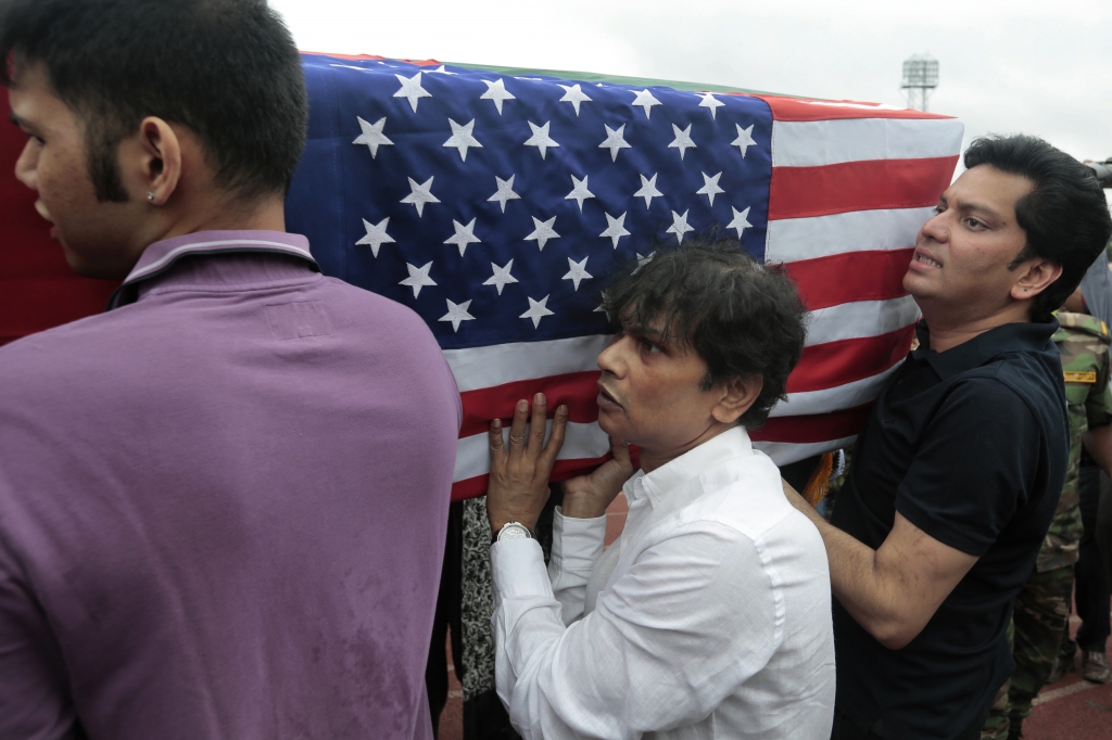 Relatives of Abinta Kabir student of Emory University of U.S. carry her coffin draped with the Bangladesh and U.S. flags after a ceremony for victims of the attack on the Holey Artisan Bakery in Dhaka Bangladesh Monday