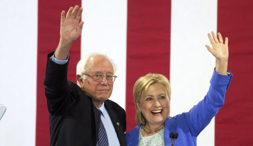 Democratic presidential candidate Hillary Clinton and Sen. Bernie Sanders wave to supporters with during a rally in Portsmouth New Hampshire where Sanders endorsed her for president