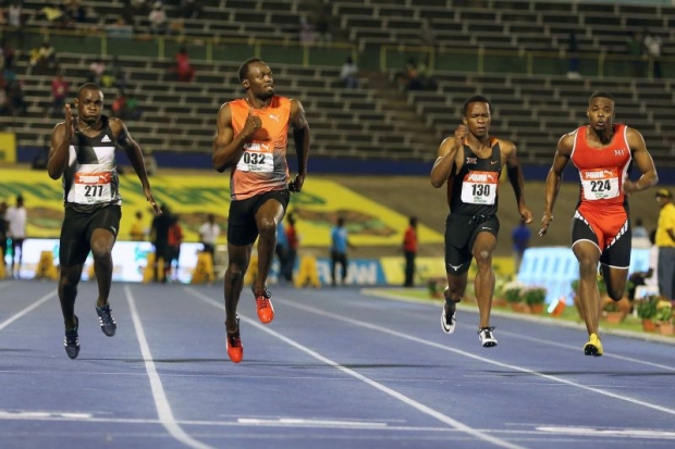 Bolt eases off to clock 10.04 seconds in his semi-final ahead of Jevaughn Minzie Senoj Jay Givans and Dexter Lee. — Reuters pic