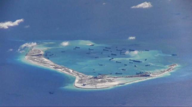 Chinese dredging vessels are purportedly seen in the waters around Mischief Reef in the disputed Spratly Islands in the South China Sea in this still image from video taken by a P-8A Poseidon surveillance aircraft provided by the United States Navy May 21