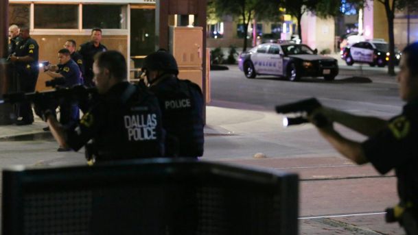 Dallas police move to detain a driver after several police officers were shot in downtown Dallas