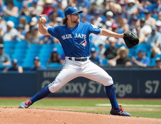 Toronto Blue Jays starting pitcher R.A. Dickey works against the Seattle Mariners during first inning American League MLB baseball action in Toronto on Saturday