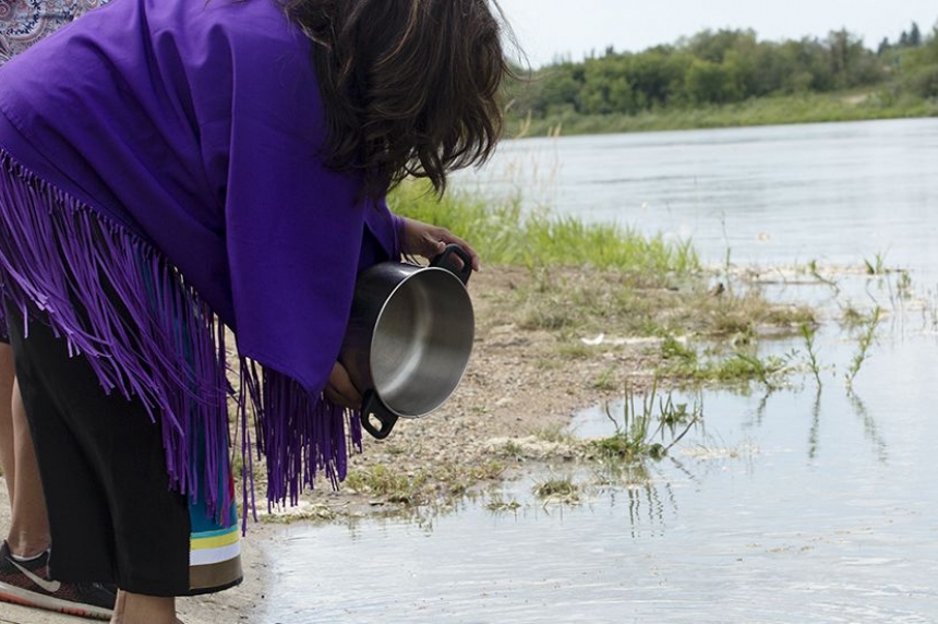 Federation of Sovereign Indigenous Nations vice Chief Kimberly Jonathan returns healthy water back to the North Saskatchewan River during a water ceremony. July 27 2016