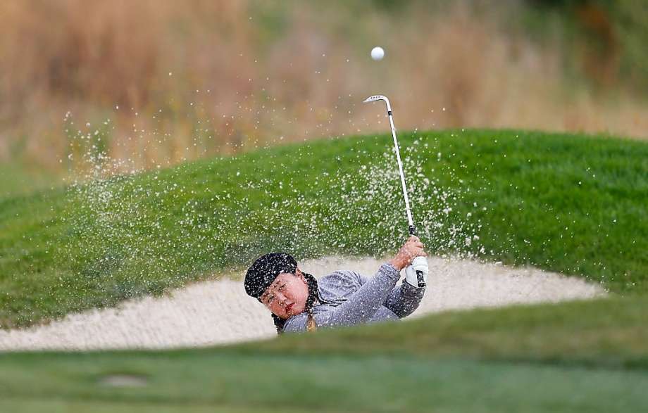 Christina Kim hits out of a bunker on the 15th hole