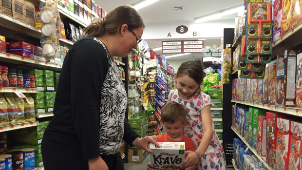 Erica Wiggins shops for groceries with her children in Georgia Vt. A new GMO-labelling law goes into effect July 1 in the state