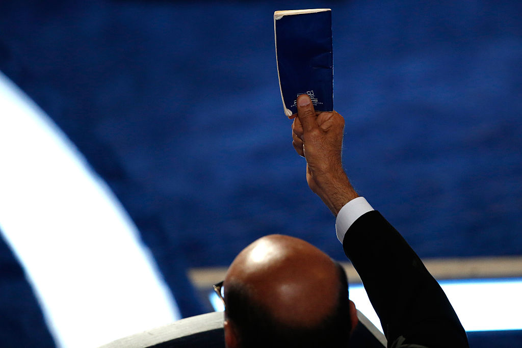 Khizr Khan father of deceased Muslim U.S. Soldier Humayun S. M. Khan holds up a booklet of the US Constitution as he delivers remarks on the fourth day of the Democratic National Convention at the Wells Fargo Center