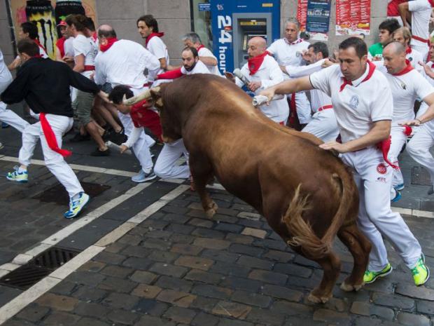 Ruunning of the Bull protesters covered in fake blood