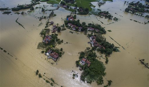 News Agency shows village houses and field partially submerged by flood waters in Gaoyang Town Shayang County central China's Hubei Province. China says dozens of