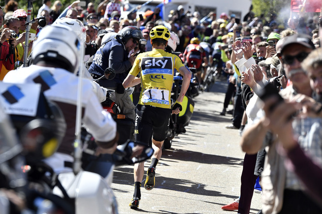 Britain's Chris Froome wearing the overall leader's yellow jersey runs after he crashed at the end of the twelfth stage of the Tour de France cycling race