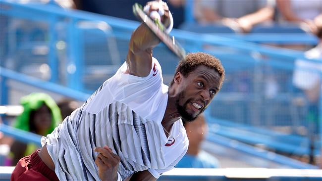 Gael Monfils serves during his 5-7 7-6 6-4 win against Ivo Karlovic at Rock Creek Tennis Center