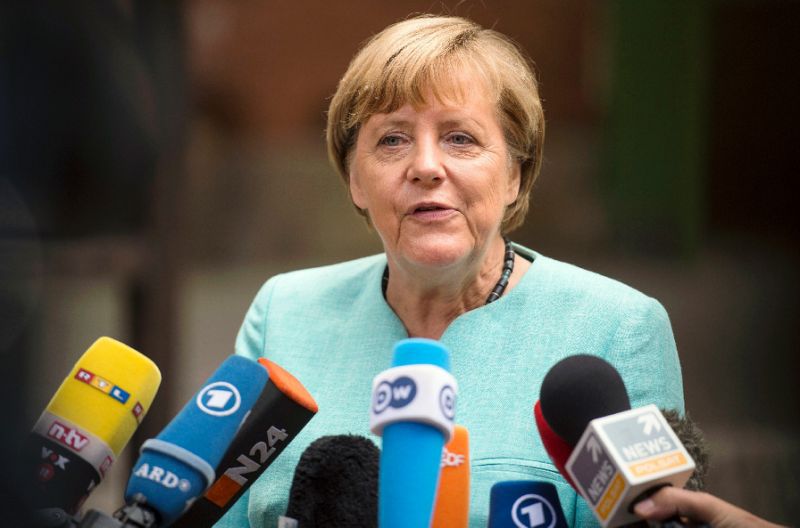 After attacks, Merkel cuts short holiday to face refugee policy storm