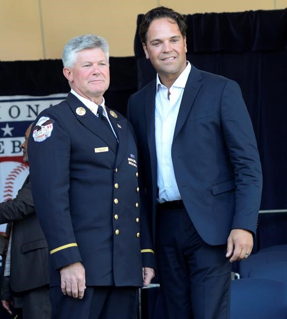 New York City Fire Department Battalion Chief Vin Mavaro left and Mike Piazza pose for