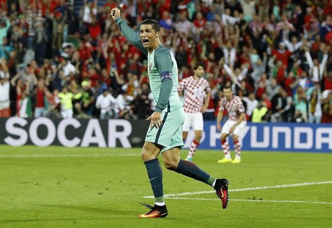 Portugal's Cristiano Ronaldo celebrates after Portugal's Ricardo Quaresma scored during the Euro 2016 round of 16 soccer match between Croatia and Portugal at the Bollaert stadium in Lens France Saturday