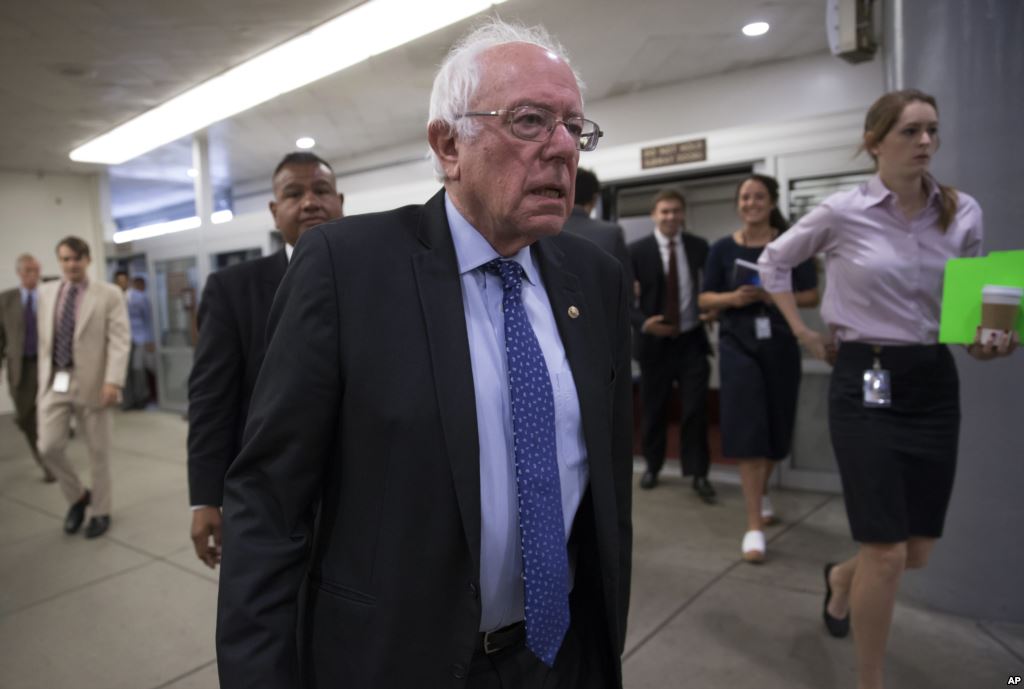 FILE- Democratic presidential candidate Sen. Bernie Sanders I-Vt. heads to the Senate chamber on Capitol Hill in Washington