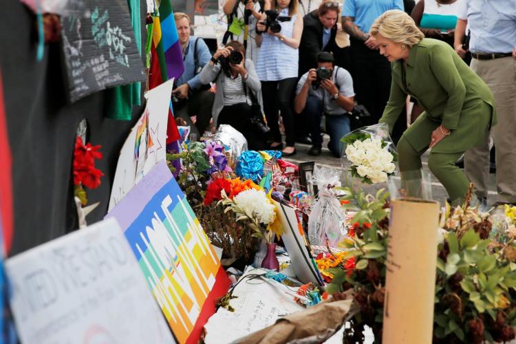 U.S. Democratic presidential candidate Hillary Clinton leaves a bouquet at the memorial outside the Pulse nightclub on Friday in Orlando