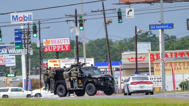 Baton Rouge Police search for a shooting suspect near Hammond Aire Shopping Center after multiple police were shot on Sunday July 17 2016. Multiple law enforcement officers were killed and wounded Sunday morning in a shooting near a gas station in Bato