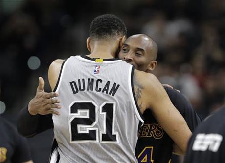 San Antonio Spurs center Tim Duncan hugs Los Angeles Lakers forward Kobe Bryant prior to an NBA basketball game in San Antonio. Tim Duncan has joined Kobe Bryant in retirement ending a two-decade chapt