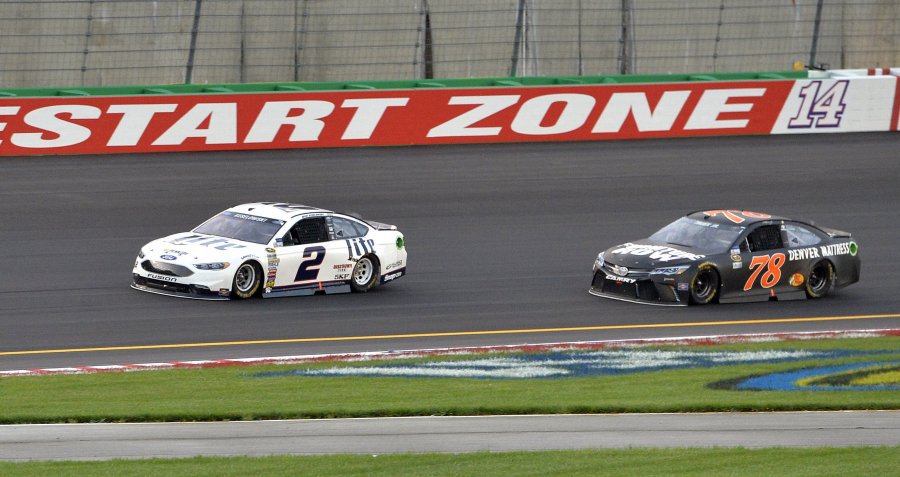 Brad Keselowsi leads Martin Truex Jr. down the front stretch during the NASCAR Sprint Cup Series auto race at Kentucky Speedway Saturday