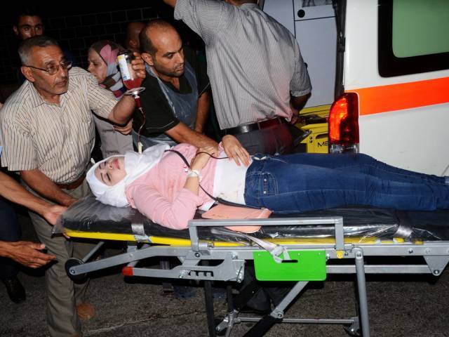 A Syrian woman who was wounded following reported shelling by rebel fighters arrives on a stretcher to a hospital in the Al Jamiliyah neighbourhood on the government-controlled side of the divided northern city of Aleppo