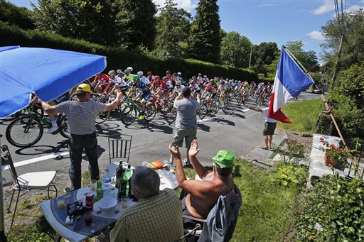 Spectators cheer as the pack passes during the fifth stage of the Tour de France cycling race over 216 kilometers with start in Limoges and finish in Le Lioran France Wednesday