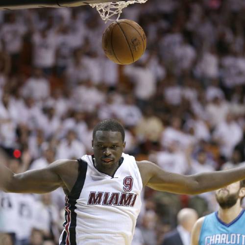 Miami Heat forward Luol Deng scores against the Charlotte Hornets during the second half of Game 2 of a first-round NBA basketball playoff series in Miami. A person with knowledge of the situation tells