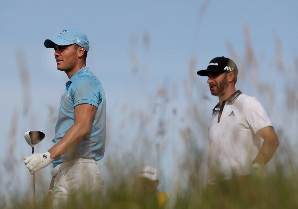 Martin Kaymer of Germany left and Dustin Johnson of the United States look down the 15th fairway from the tee during the first round of the British Open Golf Championship at the Royal Troon Golf Club in Troon Scotland Thursday