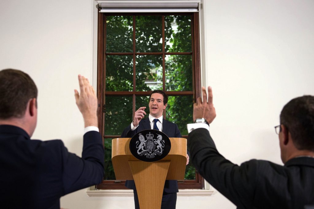 British Chancellor of the Exchequer George Osborne center speaks during a press conference at The Treasury in London on Monday