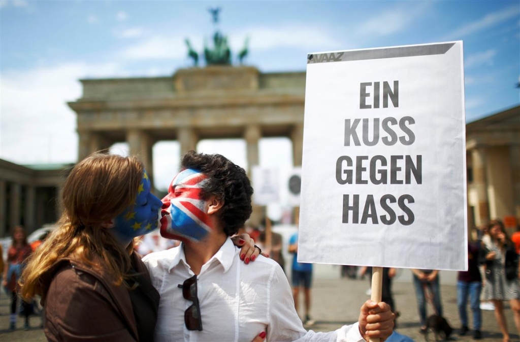 Two activists with the EU flag and Union Jack painted on their faces kiss each other in front of Brandenburg Gate last month to protest against British exit from the European Union in Berlin Germany. The sign reads ‘‘A kiss against hate’’. Pho