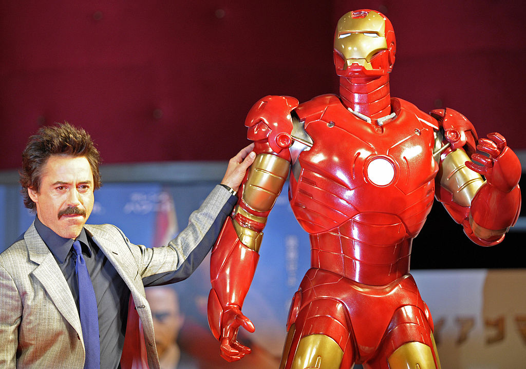 US actor Robert Downey Jr. poses by a life-size Iron Man model during a press conference on his latest movie Iron Man in Tokyo