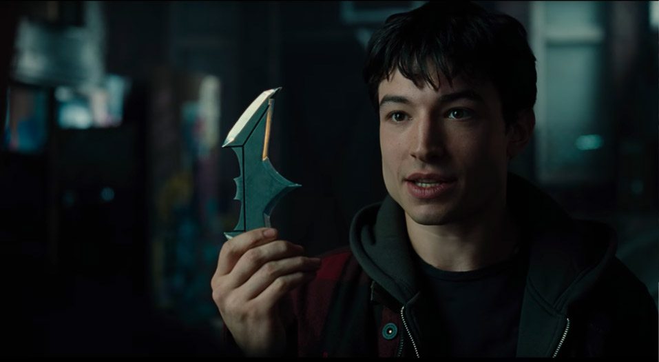 Barry Allen holding a batarang from the Justice League movie- Justice League Movie news