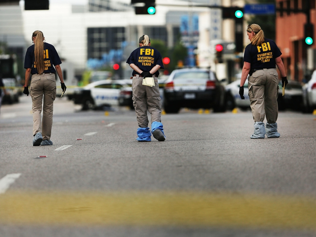 Members of an FBI evidence response team search an area in downtown Dallas following the deaths of five police officers on Thursday night