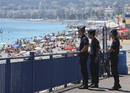 French police officers patrol on the famed Promenade des Anglais in Nice southern France three days after a truck mowed through revelers Sunday