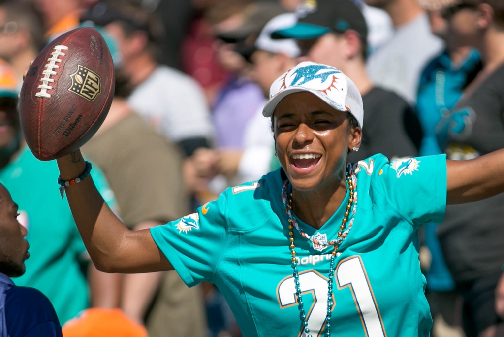 Miko Grimes celebrates after her husband Miami Dolphins cornerback Brent Grimes gave her the ball he intercepted and returned for a touchdown in the third quarter at Ever Bank Field in Jacksonville Florida