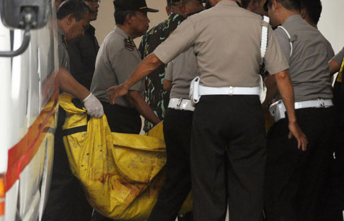 Indonesian police officers carry one of the two bodies of militants killed by Indonesian security forces upon arrival at the police hospital in Palu Central Sulawesi Indonesia on Tuesday. — AP