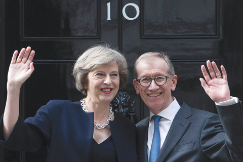 LONDON Britain's new Prime Minister Theresa May and her husband Philip John wave outside 10 Downing Street yesterday as she takes office following the formal resignation of David Cameron.- AFP