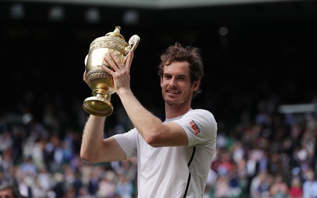 Andy Murray poses with the winner's trophy after victory over Canada's Milos Raonic