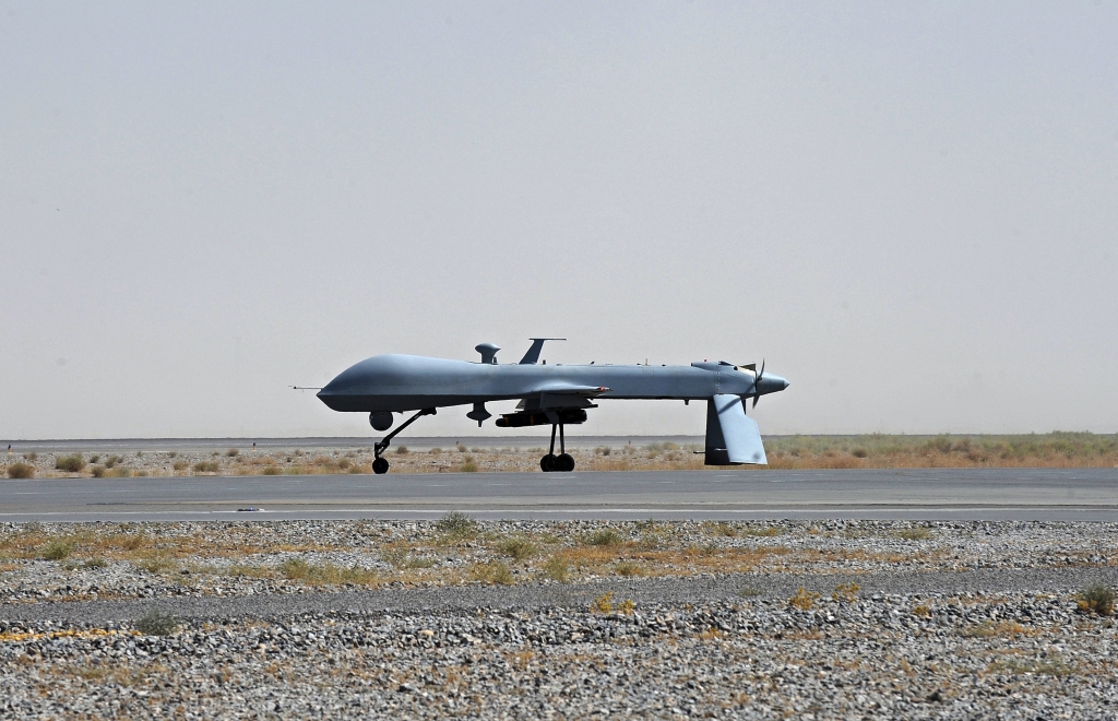 US Predator unmanned drone armed with a missile stands on the tarmac of Kandahar military airport. Times are hard