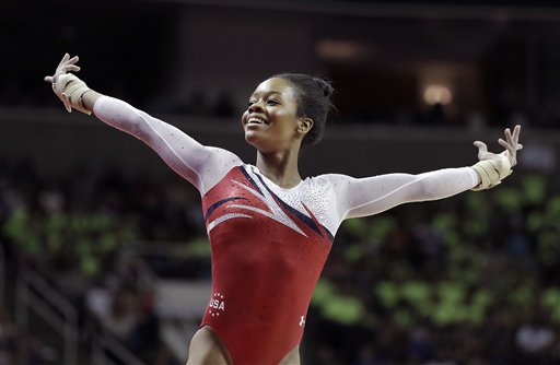 Gabrielle Douglas smiles after competing on the floor exercise during the women's U.S. Olympic gymnastics trials in San Jose Calif. Sunday