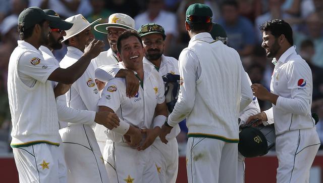Pakistan's Yasir Shah is congratulated by team mates after taking the wicket of England's Jonny Bairstow