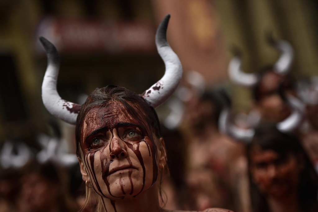 Half naked protesters are taking a stand against Spain's Running of the Bulls today