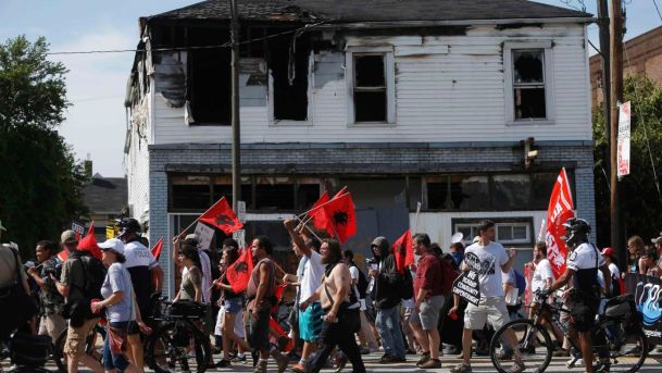 People protest Trump near an abandoned house in Cleveland during Republican National Convention. July