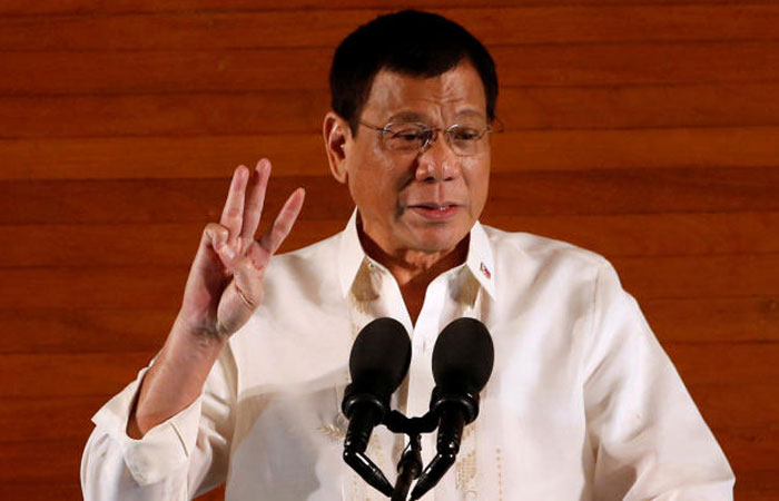 Philippine President Rodrigo Duterte gestures during his first State of the Nation Address at the Philippine Congress in Quezon city Metro Manila Philippines on Monday. — Reuters