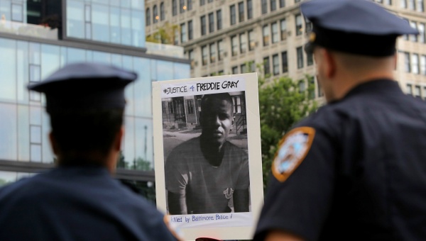 Police watch on as a man participates in a protest in Union Square