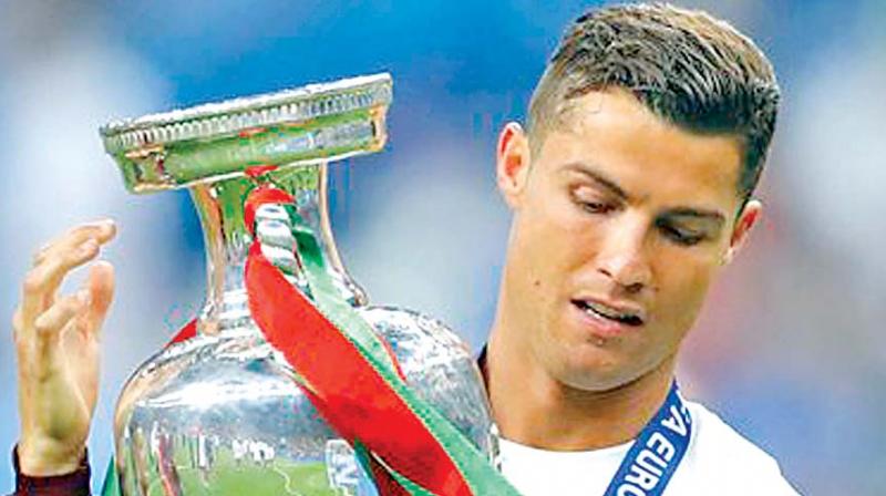 Portugal captain Cristiano Ronaldo holds the Uefa Euro trophy