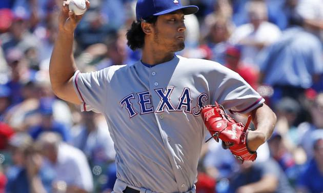 Texas Rangers starter Yu Darvish of Japan throws against the Chicago Cubs during the first inning of an interleague baseball game in Chicago Saturday