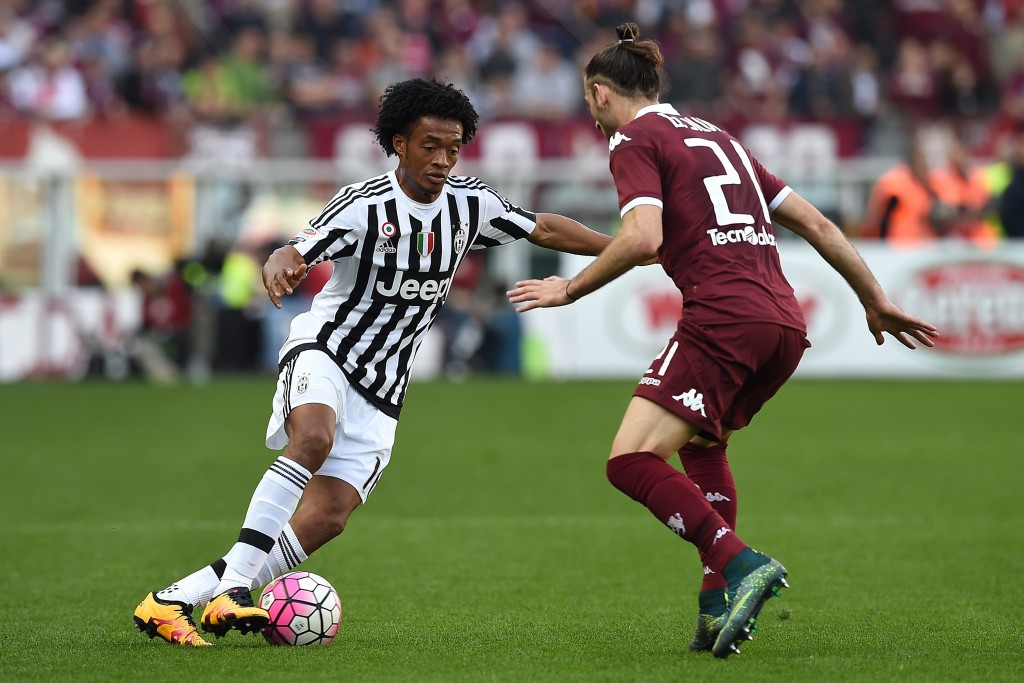 TURIN ITALY- MARCH 20 Juan Cuadrado of Juventus FC in action against Silva Gaston of Torino FC during the Serie A match between Torino FC and Juventus FC at Stadio Olimpico di Torino