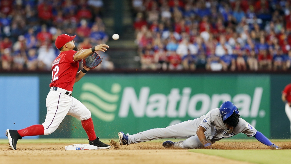 Texas Rangers second baseman Rougned Odor throws to first after forcing out Kansas City Royals&#039 Raul Mondesi at second during the third inning of a baseball game Saturday