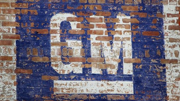 Faded GM logo on brick wall