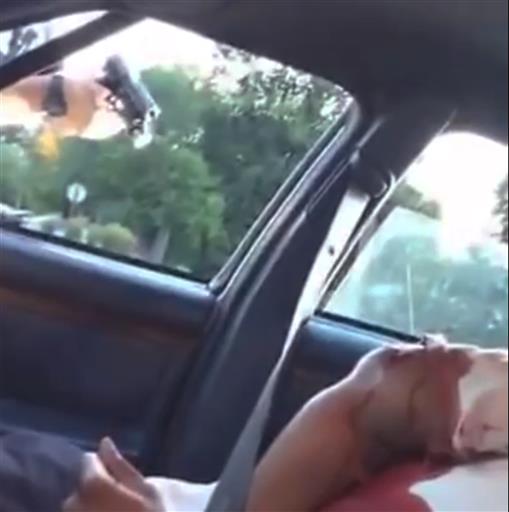 GRAPHIC CONTENT This still image taken from video by Diamond Reynolds shows a police officer pointing a gun at her boyfriend Philando Castile during a traffic stop on Wednesday in Falcon Heights MI