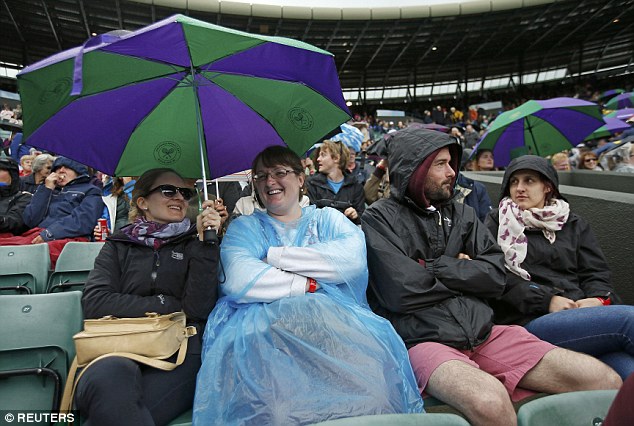 Spectators keep in good spirits despite the drizzle and damp on day five on Wimbledon 2016